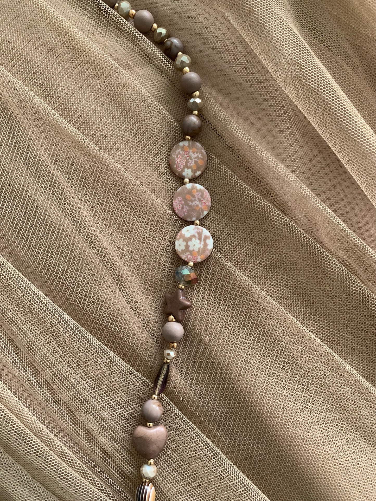 Kette Buddha braun; €29,90 statt €49,90; „ Im Black-Friday-Outlet“ ein super extravagantes Accessoire